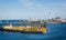 Offshore wind farm with Trekroner Fort in foreground and the Olesund bridge in the background in the Baltic Sea off Danish coast