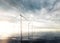 Offshore wind turbines with sunset stormy sky in background