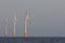 Offshore wind turbines. Windfarm on the sea horizon. Clean energy.