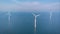 offshore windmill park with clouds and a blue sky