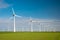 Offshore windmill park with clouds and a blue sky, windmill park in the ocean drone aerial view with wind turbine