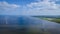 offshore windmill park with clouds and a blue sky, windmill park in the ocean drone aerial view with wind turbine