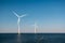 Offshore windmill park green energy in the Netherlands Europe, wind mill turbines at sea and land providing green energy