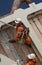 Offshore workers on work boat supply vessel, handling loads to platform.