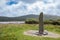 Ogham Stone in Irish Landscape Under Cloudy Blue Sky