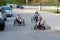 OGRE, LATVIA, - SEPTEMBER 7, 2018: Three youngsters drive the city street with their own hand-made racing tricycles