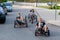 OGRE, LATVIA, - SEPTEMBER 7, 2018: Three youngsters drive the city street with their own hand-made racing tricycles