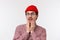 Oh gosh omg. Surprised and speechless hipster guy with beard in red beanie, glasses, gasping staring at something