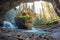 Ohnston Canyon cave in Spring season with waterfalls, Johnston Canyon Trail, Alberta, Canada
