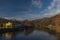 Ohre river in Perstejn village with blue sky and color forests and mountains