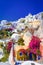 Oia, Santorini island, Greece. Traditional and famous white houses and churches with blue domes over the Caldera, Aegean sea.