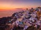 Oia village, Santorini, Greece. View of traditional houses in Santorini. Small narrow streets and rooftops of houses, churches and