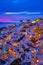 Oia village, windmills, Santorini island, Greece at colorful sunset