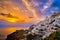 Oia village, windmills, Santorini island, Greece at colorful sunset