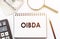 OIBDA Operating Income Before Depreciation And Amortization - text written on a notebook with office background