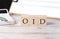 OID -ORIGINAL ISSUE DISCOUNT word on a wooden block with clipboard and calcuator