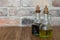 Oil and balsamic vinegar glass bottles with spouts on rustic brick wall background with copy space