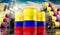 Oil barrels with flag of Colombia and oil extraction wells - 3D illustration