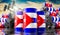 Oil barrels with flag of Cuba and oil extraction wells - 3D illustration