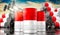 Oil barrels with flag of Indonesia and oil extraction wells - 3D illustration