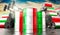 Oil barrels with flag of Italy and oil extraction wells - 3D illustration
