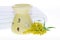 Oil burner yellow flower and white towel