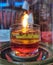 An oil burning candle in a transparent glass