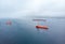 Oil chemical tanker sails blue sea fog. Aerial top view