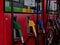 Oil dispenser with different colored fuel nozzles  in the gas station.