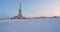 Oil drilling rig. Winter at dawn in the snow