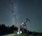 Oil field with pump jack under beautiful night sky.