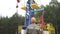 Oil field technical worker overseeing oil pumping unit in site of crude oil production. Industrial oil pump jack working