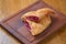 Oil fried crunchy pie. Fruit closed pie cut in half. Cherry hot pocket pie served on a wooden board.