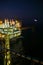 Oil and gas construction in night view. View from helicopter night flight. Oil and gas platform in offshore.