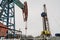 Oil and Gas Drilling Rig onshore dessert with dramatic cloudscape. Oil drilling rig operation on the oil platform in oil and gas