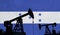 Oil and gas industry background. Oil pump silhouette against honduras flag. 3D Rendering