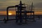 Oil, gas industry. Group wellheads and valve armature, gas production process, backlight, natural shading by sunlight