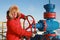 Oil and gas industry. A man in a red jacket opens a gas well to work