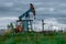 Oil and gas industry. Silhouette oil pumps on a sunset sky background. Toned.