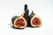 Oil in a glass bottle with a pipette. A bottle of fig oil with fresh fruit on a white background. Organic natural bio-oil.