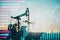 Oil industry exchange market concept with sunset oil pump jacks and digital screen with horizontal pink and blue arrows and