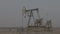 Oil industry, Pumping petroleum Rig in desert. Pump Jack Extracting Crude Oil from a Oil Well. Fossil Fuel Energy