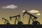 Oil industry Silhouette of oil or gas drilling rigs on a sunset background.