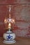 Oil lamp with a blue heart on red barn board