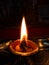 An oil lamp lit as an offering to for worship with selective focus and blurred background