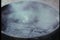 Oil mixed in water boiling in a cauldron