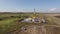 Oil and natural gas production, aerial view of well in field in summer day