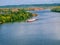 Oil paint drawing of a barge sailing along a river canyon.