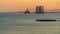 Oil platforms in the sea at sunset