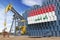 Oil production and extraction in Iraq. Oil pump jack and oil barrels with Iraqui flag